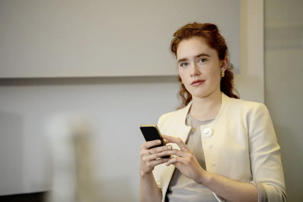 Junge Frau hält Smartphone in der Hand