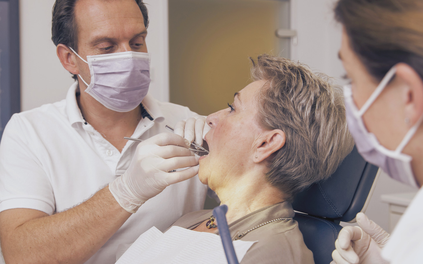 Foto: Ein Zahnarzt behandelt gerade eine Patientin.