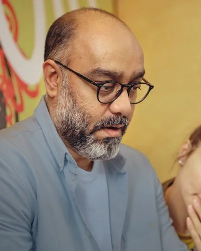 Eine Mann und eine Frau stehen nebeneinander und schauen konzentriert auf einen Laptop