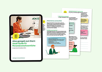 Azubi-Guide Das Titelblatt des Azubi-Guides zeigt eine Frau im orangefarbenen Blazer, die am Schreibtisch sitzt und am Computer arbeitet.