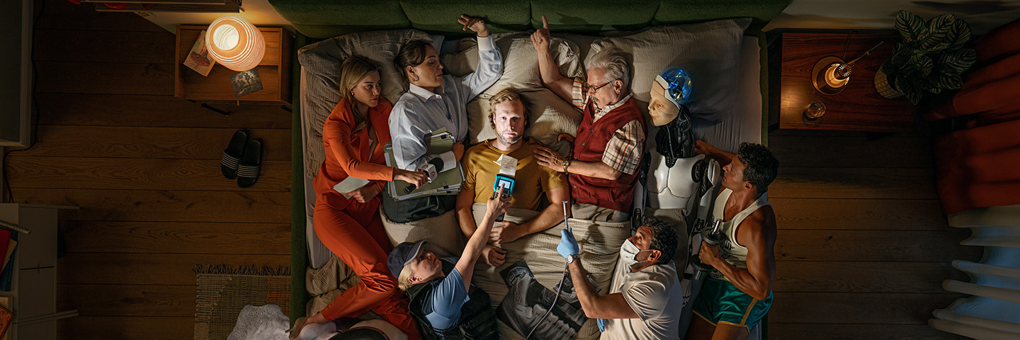 Gesunden Schlaf fördern: Viele Personen hindern eine Person im Bett am Einschlafen. Gesunden Schlaf fördern: Viele Personen hindern eine Person im Bett am Einschlafen.