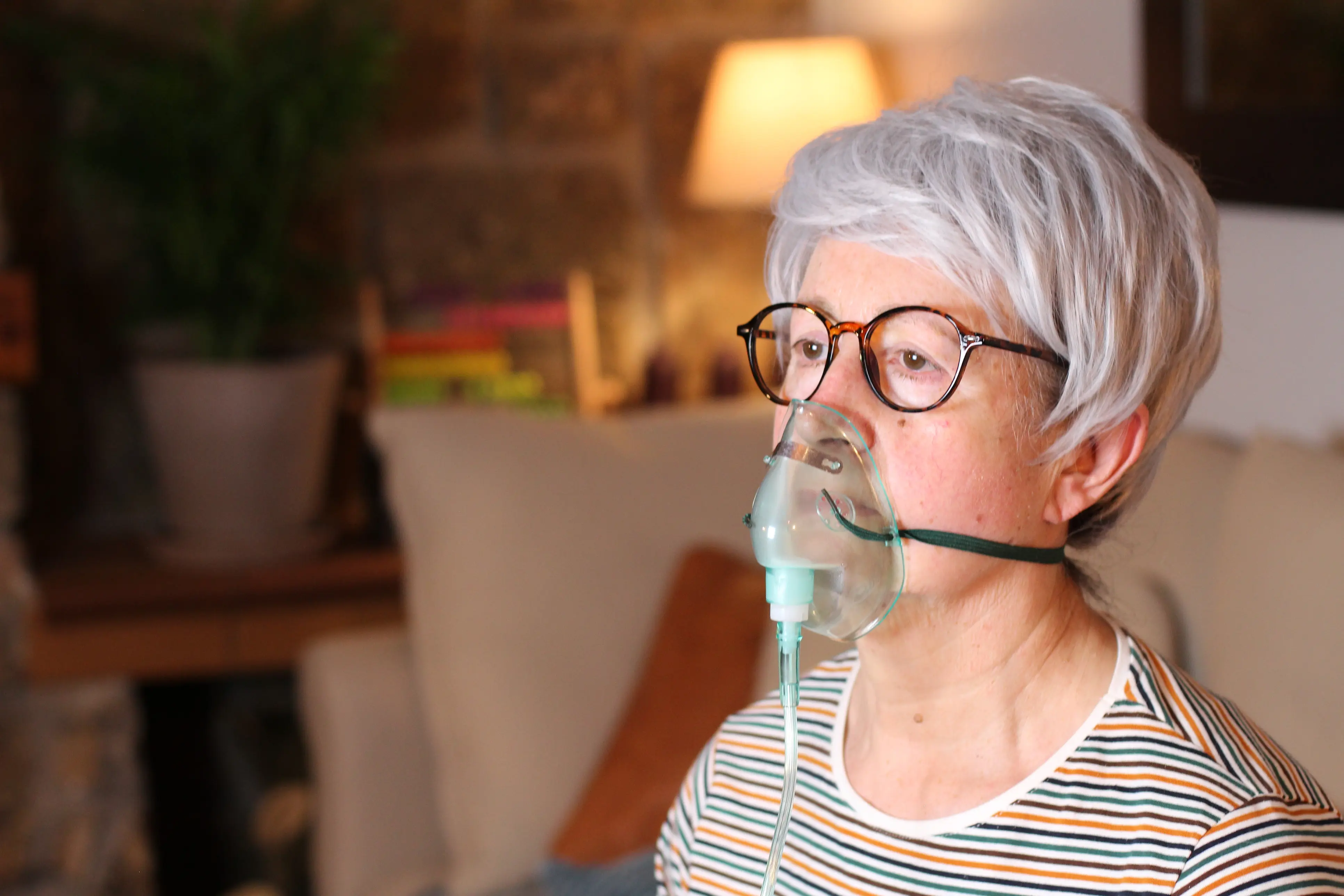 Seniorin mit Beatmungsgerät zu Hause (Symbolbild)