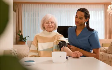 Pflegeheim: Eine Pflegerin misst den Blutdruck einer Bewohnerin.