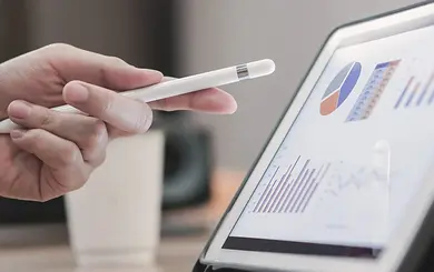 Hand, die mit einem Stift auf ein Chart zeigt