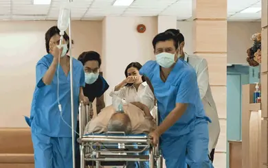 Foto: Klinikteam schiebt Notfallpatienten auf einer Liege durch den Flur
