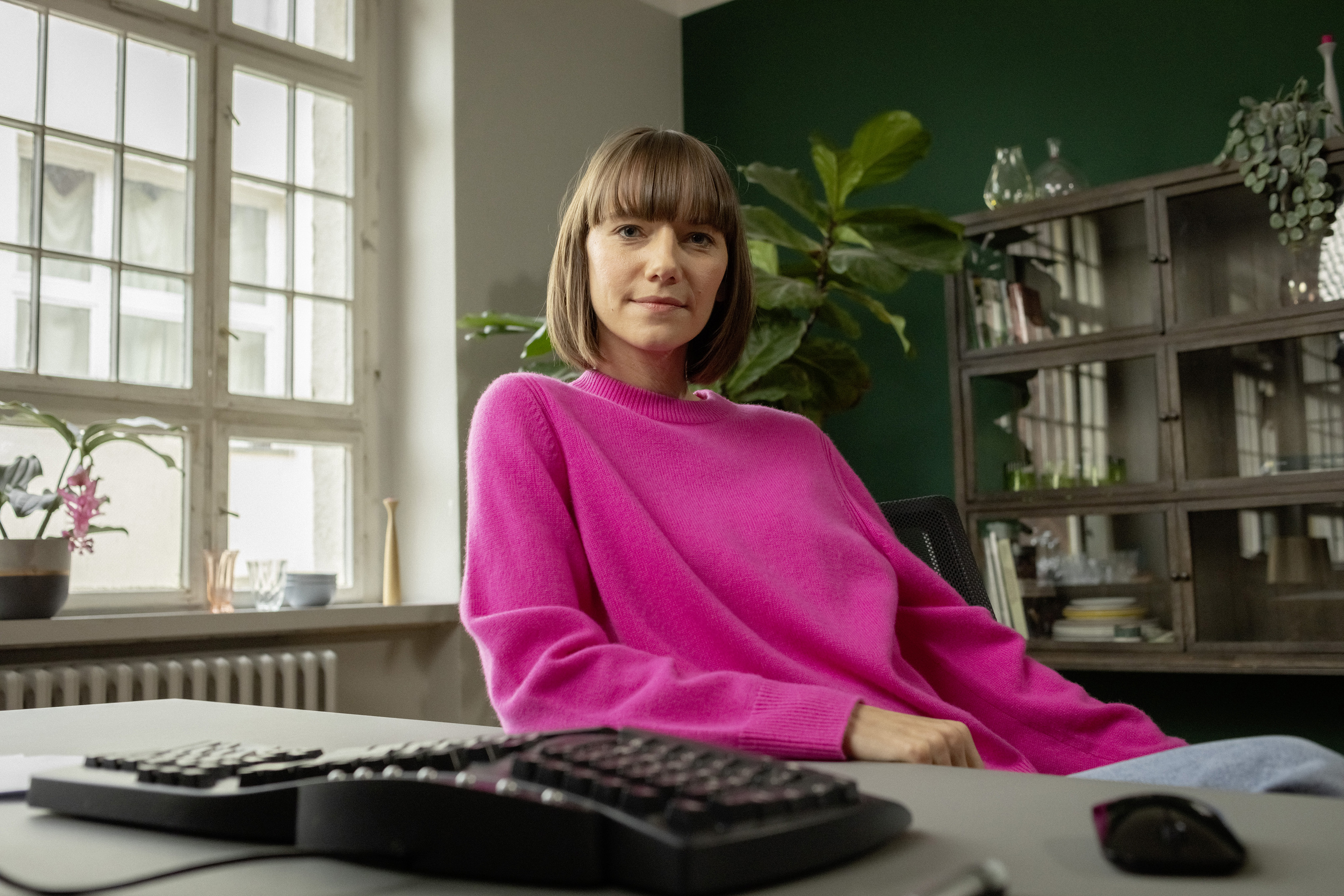 Eine berufserfahrene Frau sitzt am Schreibtisch im Homeoffice.