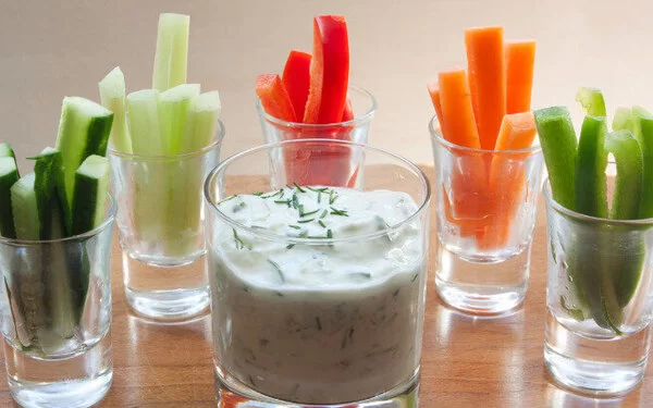 Gemüsesticks und Quark in Gläsern serviert sind ein toller Low-Carb-Snack.