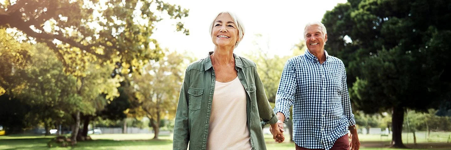 Ein Seniorenpaar geht gemeinsam spazieren.