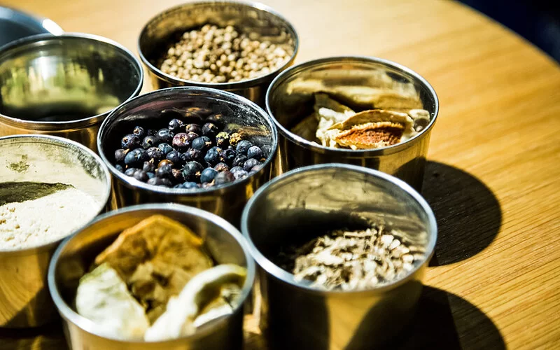 Botanicals wie Wachholderbeeren für alkoholfreien Gin auf einem Tisch.