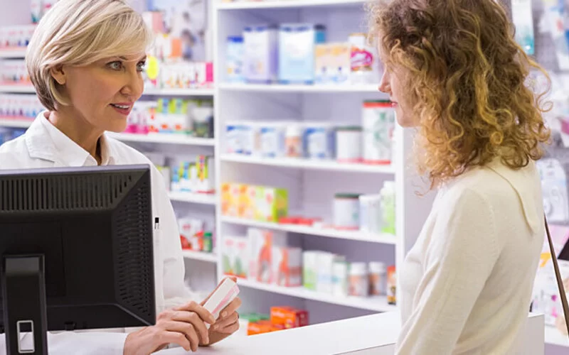 Eine junge Frau erhält von einer Apothekerin Beratung zu der Pille danach.