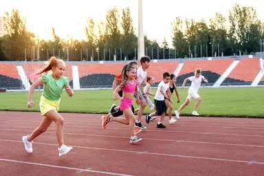 Kinder beim Laufwettbewerb im Stadion.