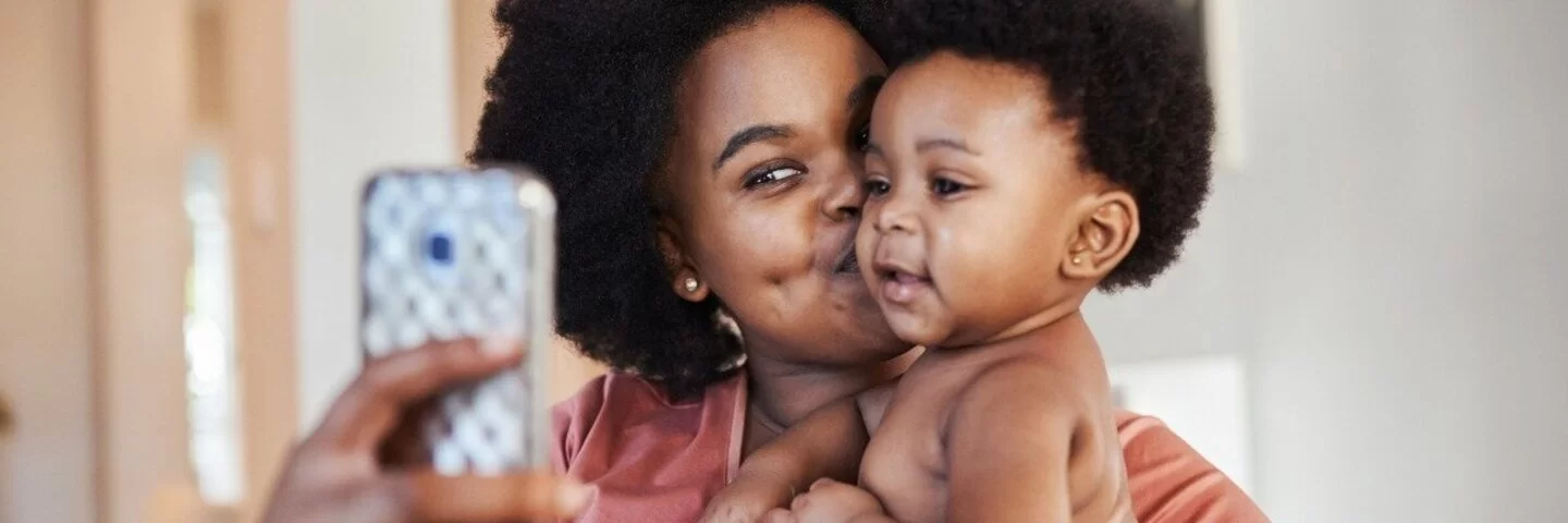 Eine Mutter macht ein Selfie mit Baby