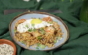 Fried Kimchi Rice mit Spiegeleiern auf einem Teller serviert.