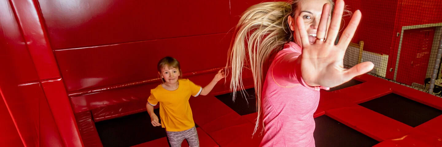 Mutter und Kind haben Spaß am Wochenende in einer Trampolinhalle.