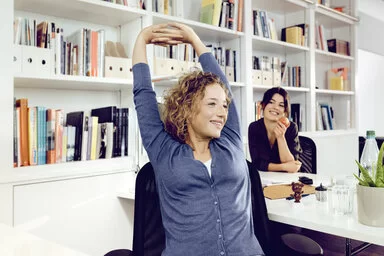 Eine Frau entspannt sich während ihrer Arbeitspause. Das AOK-Programm “Lebe Balance” hilft ihr, mehr Achtsamkeit in den Alltag zu integrieren.