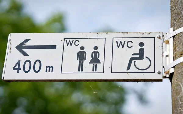 Ein Wegweiser zeigt den Weg zu einer öffentlichen Toilette, die 400 Meter entfernt ist.