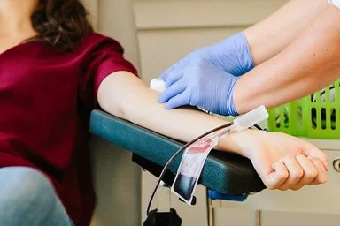 Frau bei Blutspende.