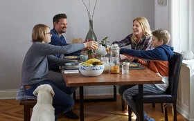 Familie Seidel sitzt zusammen am Frühstückstisch. 