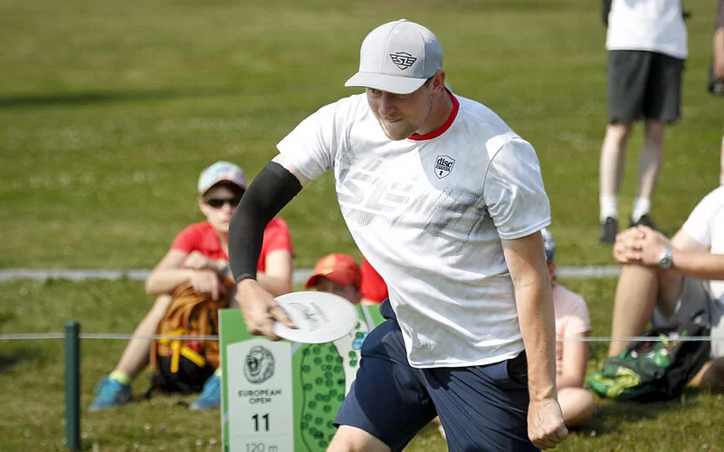 Der deutsche Discgolfprofi Simon Lizotte beim Werfen einer Discgolfscheibe.