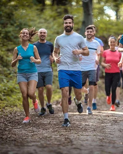 Eine Gruppe Menschen läuft zusammen im Wald.