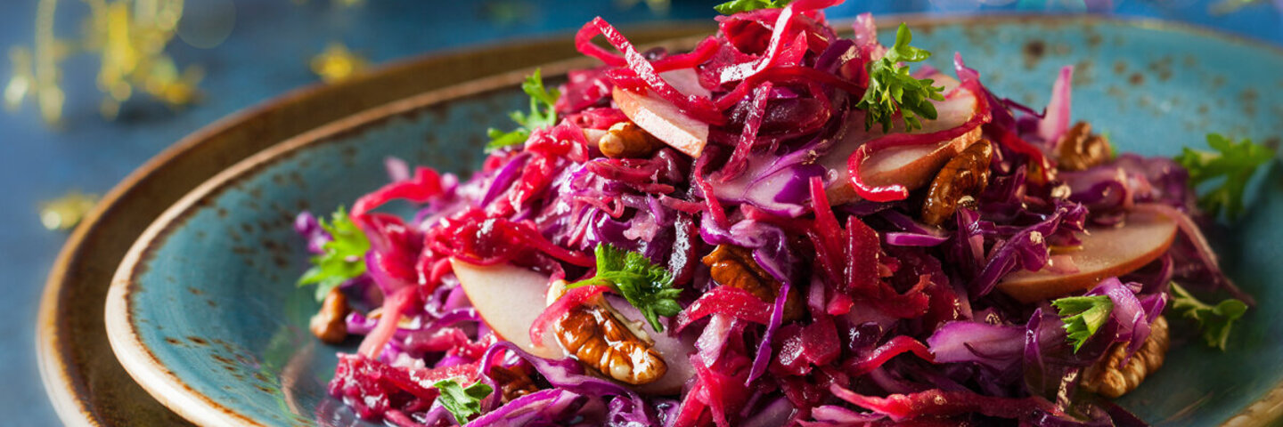 Festlicher Rotkohl-Salat als Vorspeise an Weihnachten auf einem blauen Teller serviert.