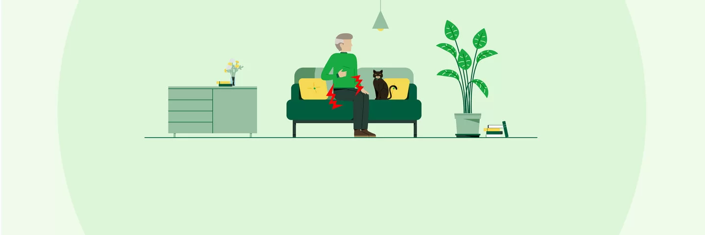 Die Illustration zeigt einen älteren Mann mit Katze auf einem Sofa. Symbole deuten an, dass der Mann Schmerzen im Unterleib hat.