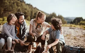 Eine Familie macht Pause auf einer Wanderung.