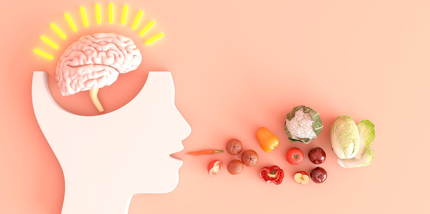 Foto: Illustration eines Kopfes mit sichtbarem Gehirn – vor dem Mund liegt Obst und Gemüse.