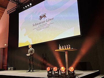 Schwarzer Löwe Moderator auf der Bühne währen der Preisverleihung Schwarzer Löwe 2024